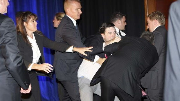 Security throw out the man who hopped on stage during Mr Abbott's speech at the Four Seasons hotel in Sydney.