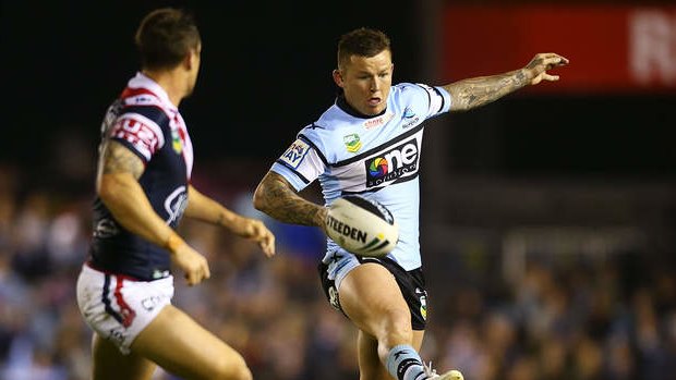 Kicking on: Sharks five-eighth Todd Carney puts boot to ball against his former club.