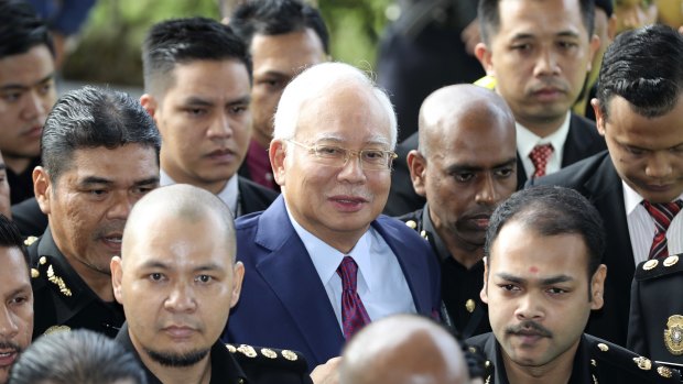 Former Malaysian Prime Minister Najib Razak, centre, arrives at a court house in Kuala Lumpur on Wednesday.