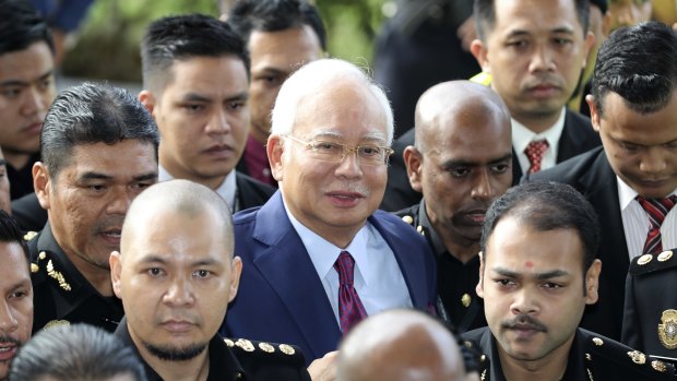 Former Malaysian Prime Minister Najib Razak, centre, arrives at a court house in Kuala Lumpur on Wednesday.