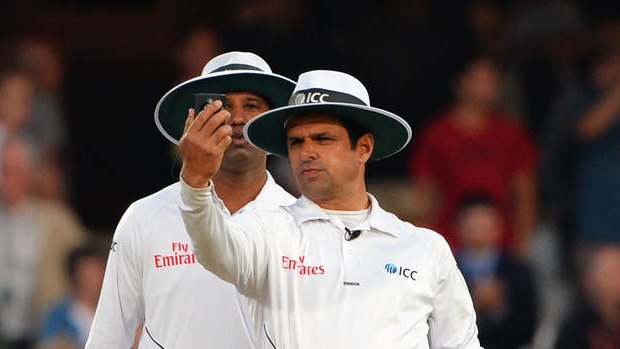 Umpires Aleem Dar (right) and Kumar Dharmasena take a light-metre reading late on the final day of the fifth Ashes Test at The Oval.