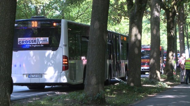 A bus stands on a street in Luebeck after passengers were stabbed.