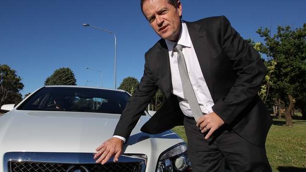 Opposition Leader Bill Shorten gets into his Holden COMCAR on his arrival in Canberra. Photo: Alex Ellinghausen