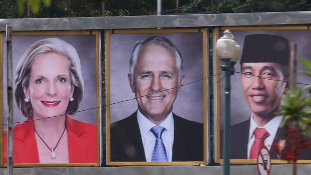 Prime Minister Malcolm Turnbull and his wife Lucy on a billboard with Indonesian President Joko Widodo near the Presidential Palace in Jakarta, Indonesia on Thursday.