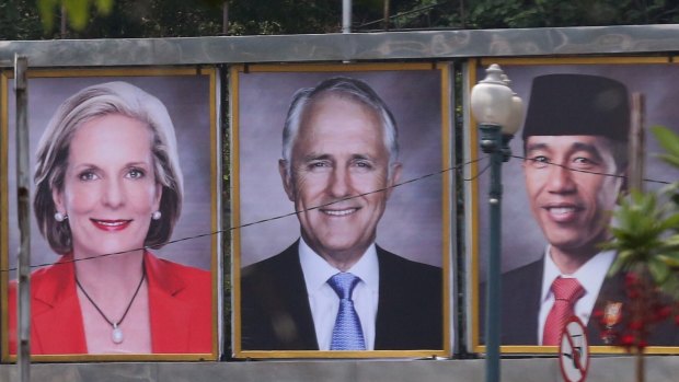 Prime Minister Malcolm Turnbull and his wife Lucy on a billboard with Indonesian President Joko Widodo near the Presidential Palace in Jakarta, Indonesia on Thursday.