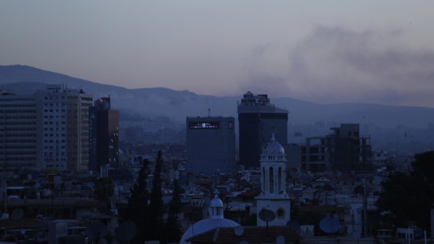 Smoke rises after air strikes targeting different parts of the Syrian capital Damascus early on Saturday.