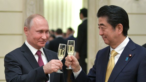 Russian President Vladimir Putin, left, and Japanese Prime Minister Shinzo Abe, toast after an opening ceremony of the cross-cultural year of Russia and Japan at the Bolshoi Theater in Moscow, Russia last week.