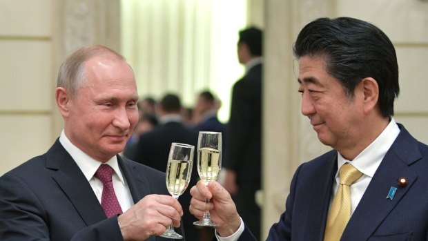 Russian President Vladimir Putin, left, and Japanese Prime Minister Shinzo Abe, toast after an opening ceremony of the cross-cultural year of Russia and Japan at the Bolshoi Theater in Moscow, Russia last week.