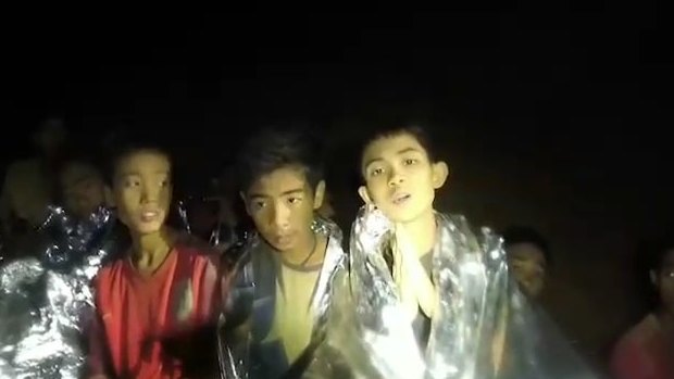 Some of the trapped boys praying in the cave in Tham Luang.