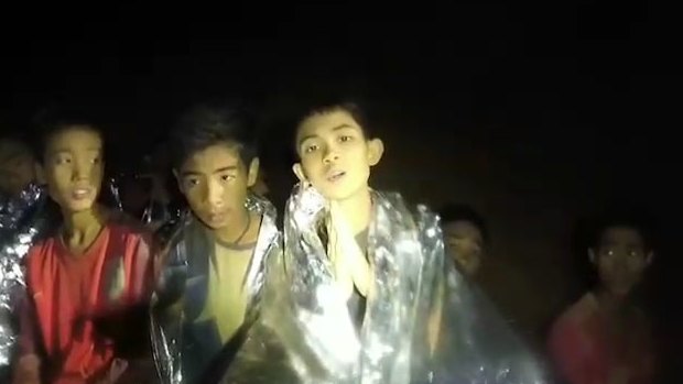 Some of the trapped boys praying in the cave in Tham Luang.