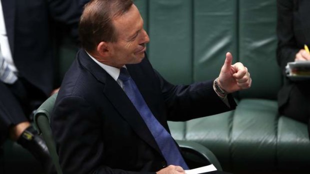 Prime Minister Tony Abbott gives the thumbs-up to Deputy Prime Minister Warren Truss during Question Time. Photo: Alex Ellinghausen