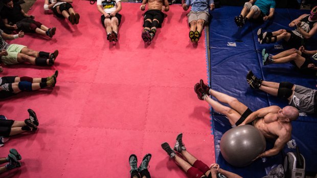 Twist circle: The wrestling class sit with arms, legs and back off the ground while a ball is passed around.