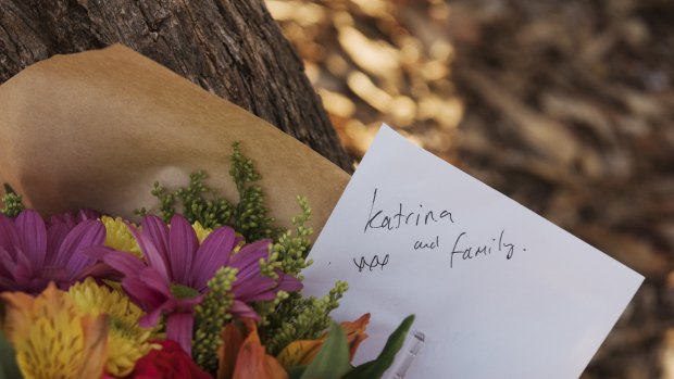 Flowers have been left outside the Osmington property where the bodies of seven people were found. 