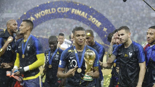 France's Kylian Mbappe celebrates with the trophy after the final match between France and Croatia at the 2018 soccer World Cup