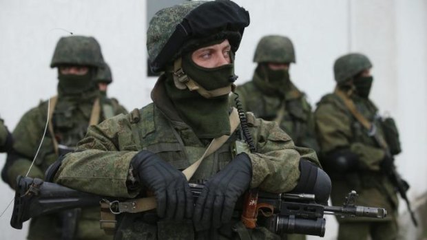 Hundreds of soldiers have taken up positions around Ukrainian military bases in Crimea.