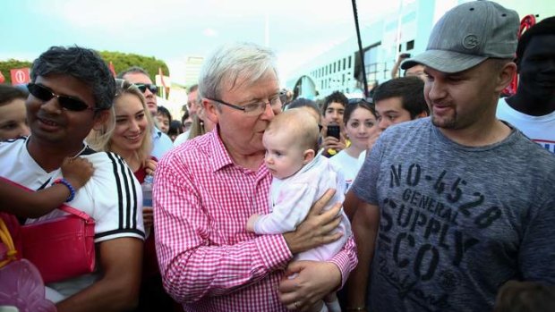 Prime Minister Kevin Rudd kisses his first baby of the campaign - Harper Florea - at the EKKA Brisbane Show on Wednesday.
