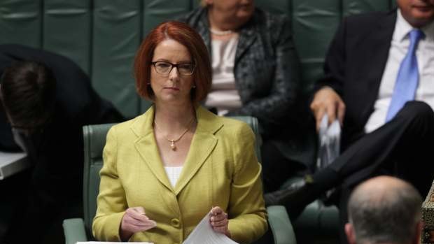 Prime Minister Julia Gillard listens to the opposition's immigration spokesman Scott Morrison in question time on Monday.