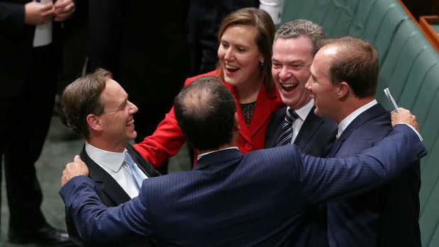 Environment Minister Greg Hunt congratulated by colleagues after Carbon Tax Repeal Bills pass the lower house. Photo: Alex Ellinghausen