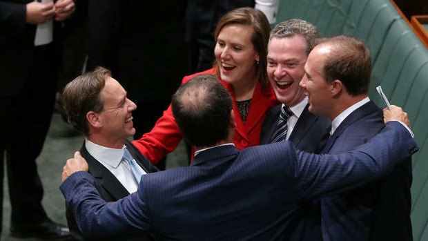 Environment Minister Greg Hunt congratulated by colleagues after Carbon Tax Repeal Bills pass the lower house. Photo: Alex Ellinghausen