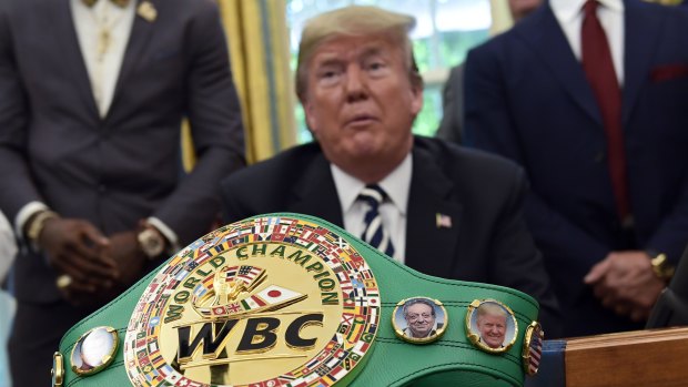 A boxing belt presented to President Donald Trump, sits on the desk in Oval Office of the White House in Washington.