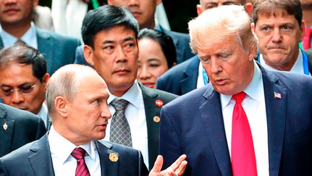 Masters of misinformation: US President Donald Trump, right, and his Russian counterpart Vladimir Putin at the APEC summit in Vietnam in November.