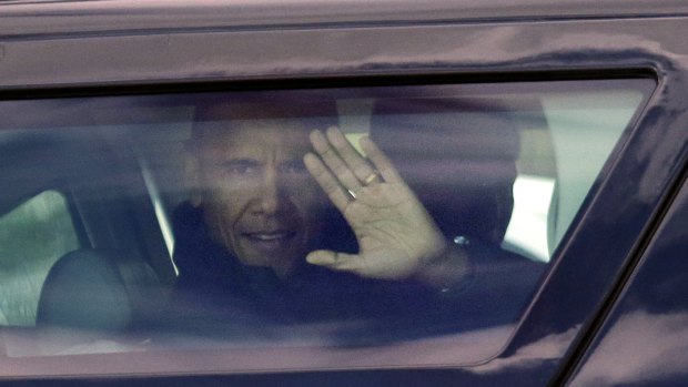 Then President Barack Obama waves from his car.