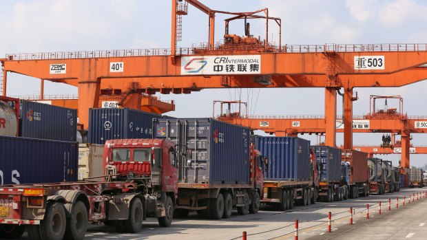 Trucks lined up to load containers at Chongqing Western Logistics Park .