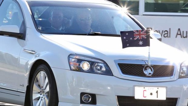 Prime Minister Tony Abbott arrives in Canberra after his visit to South Africa. And leaves the airport in the prime ministerial Holden.  Photo: Alex Ellinghausen