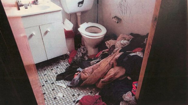 The piles of clothes were stacked so high the children would have to step onto them to use the toilet, which itself was caked in faeces, police said.