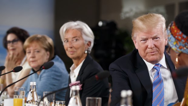 US President Donald Trump, second right, shakes hands with Winnie Byanyima, executive director of Oxfam International, after arriving late for the Group of Seven (G7) Gender Equality Advisory Council Breakfast at the G7 Leaders Summit in La Malbaie, Quebec, Canada.