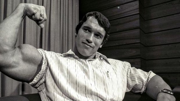 Arnold Schwarzenegger, who visited Sydney in 1974 as the reigning Mr Universe, flexes his muscles.