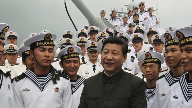 Xi Jinping, centre, talks to sailors onboard the Haikou navy destroyer during his inspection of the Guangzhou military theatre of operations of the People's Liberation Army in Guangzhou, China. 