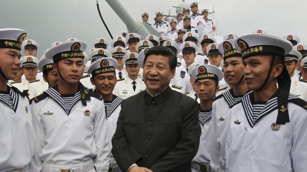 Xi Jinping, centre, talks to sailors onboard the Haikou navy destroyer during his inspection of the Guangzhou military theatre of operations of the People's Liberation Army in Guangzhou, China. 