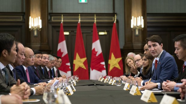 Canadian Prime Minister Justin Trudeau, right, meets with the Prime Minister of Vietnam, third from left, Nguyen Xuan Phuc,on the sides of the G7.