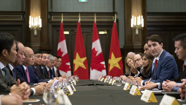 Canadian Prime Minister Justin Trudeau, right, meets with the Prime Minister of Vietnam, third from left, Nguyen Xuan Phuc,on the sides of the G7.