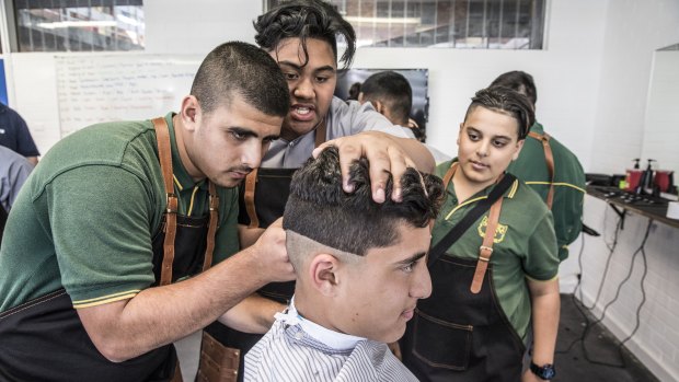 Rabin Elkheir gets an urban fade cut courtesy of fellow students at Granville Boys High's new barber shop. 