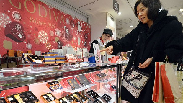 A Japanese woman buys chocolate from Belgian brand Godiva at Tokyo's Takashimaya department store.