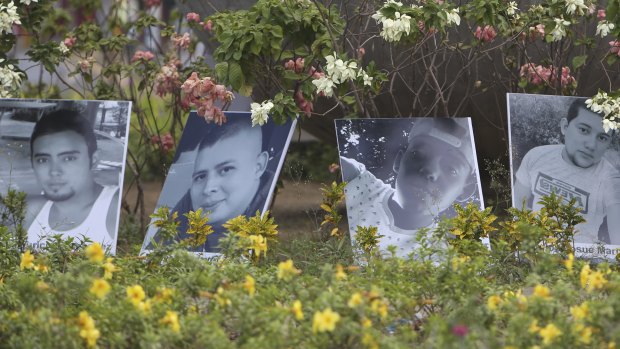 Photos of people killed in protests are displayed in a roundabout in Managua.