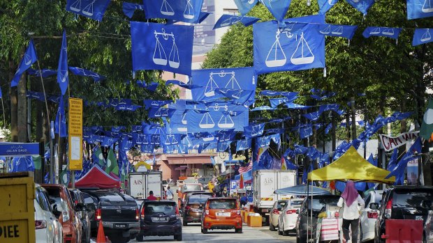 A street in Kampung Baru - Kuala Lumpur, Malaysia, covered by Barisan Nasional party flags and banners. Some banners were printed in China. 24 April 2018.