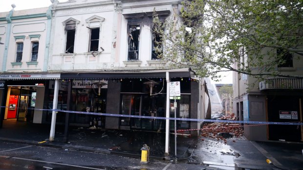 MFB fire crews work to put out the last of the flames at a fire inside a restaurant in Lygon street in Carlton 