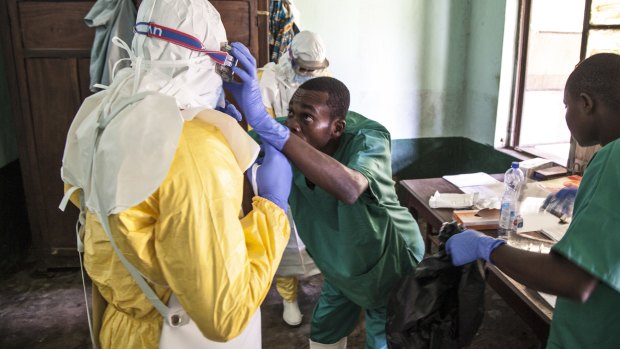 Health workers don protective clothing as they prepare to attend to patients in the isolation ward to diagnose and treat suspected Ebola patients, at Bikoro Hospital in Bikoro.