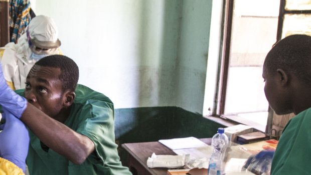 Health workers don protective clothing as they prepare to attend to patients in the isolation ward to diagnose and treat suspected Ebola patients, at Bikoro Hospital in Bikoro.