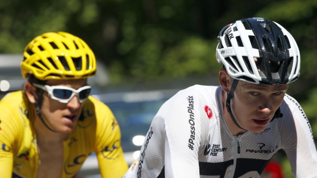 Geraint Thomas, left, wearing the overall leader's yellow jersey and Chris Froome ride during stage 12.