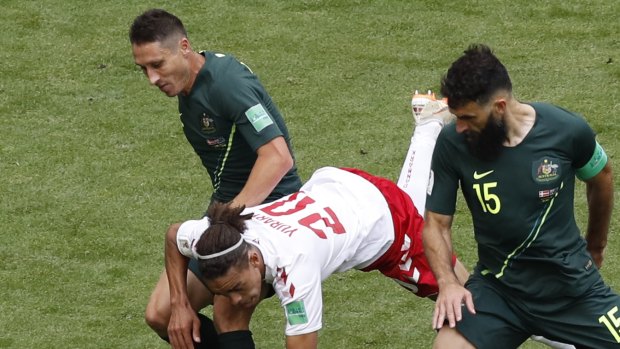 Veteran and leader: Mark Milligan, left, teams with Mile Jedinak against Denmark.