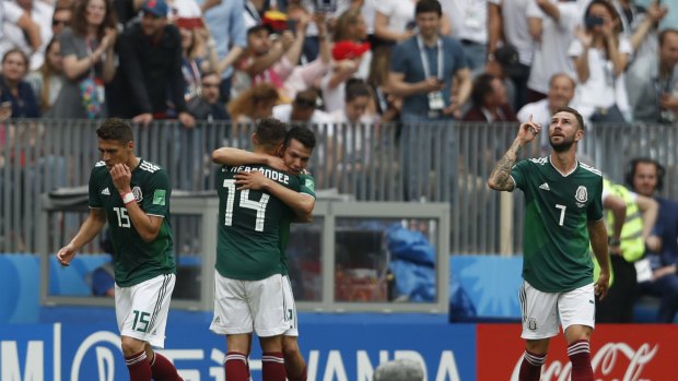 Mexico players celebrate the winning goal by Hirving Lozano.