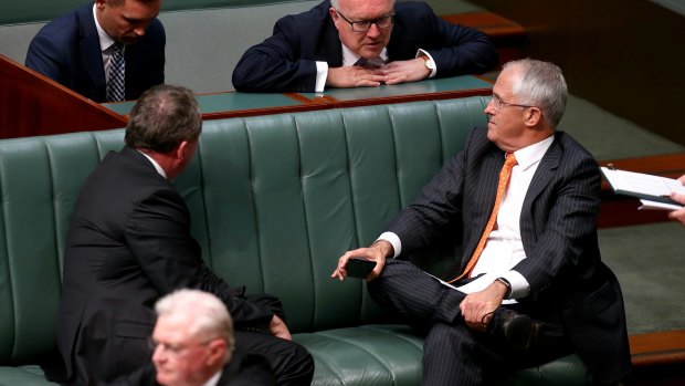 Deputy Prime Minister Barnaby Joyce, Attorney-General Senator George Brandis and Prime Minister Malcolm Turnbull in discussion during a division in the House of Representatives in Canberra on Monday.