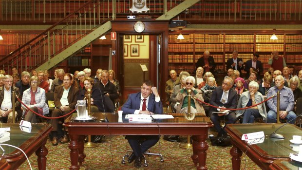 Mike Baird gives evidence before a packed public gallery. 