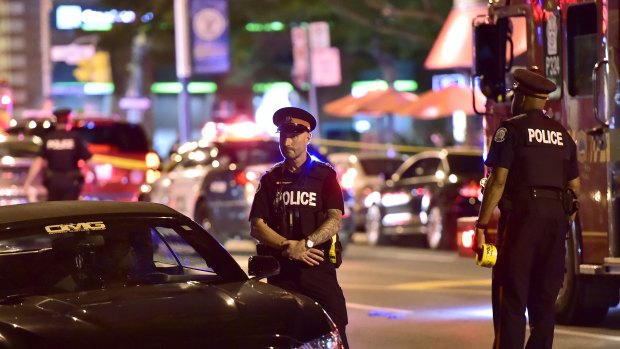 Police work the scene of a shooting in Toronto.