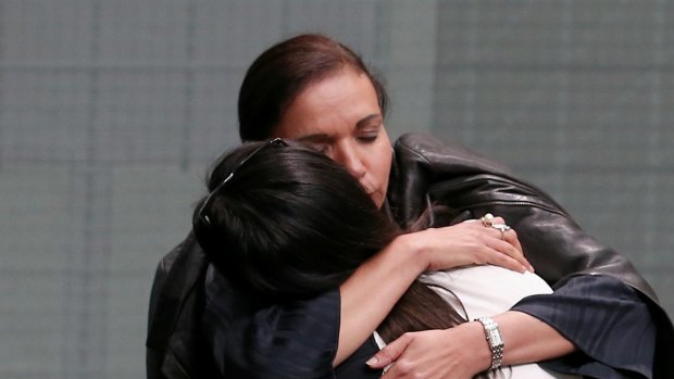 Anne Aly embraces Emma Husar after she spoke about family violence on Tuesday.