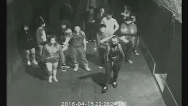 Shengliang Wan seen in CCTV footage with his hands on his head.